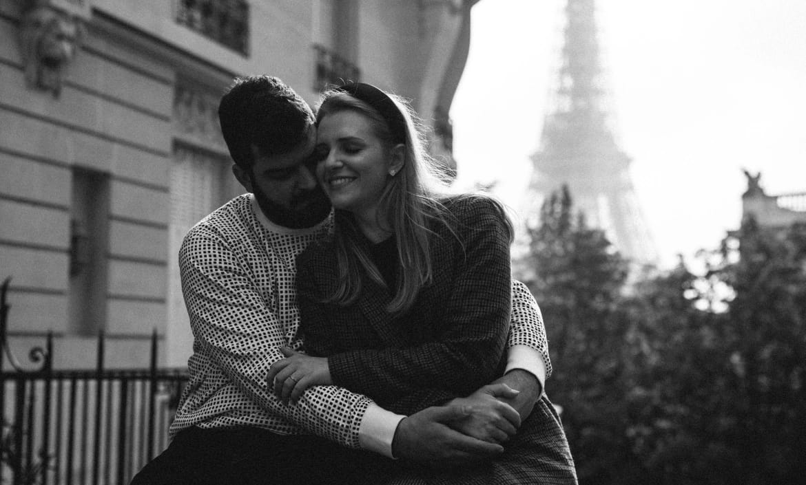 Black and white intimate couple portrait with Eiffel Tower backdrop, Paris engagement session