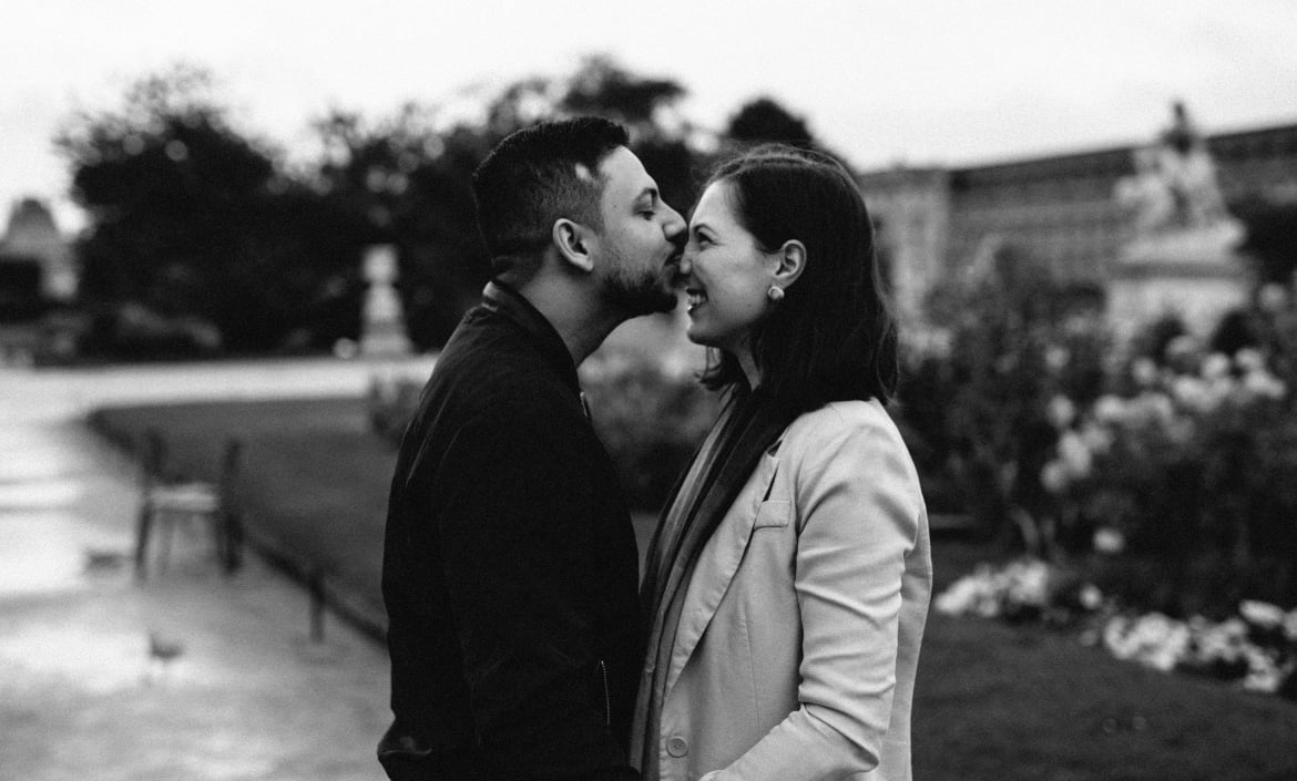 Romantic black and white couple portrait in a Parisian garden, intimate engagement photography session