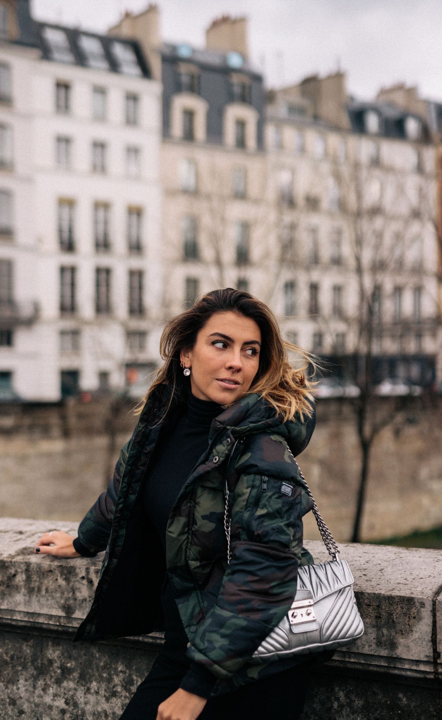 Photo of a woman in Paris posing on a bridge